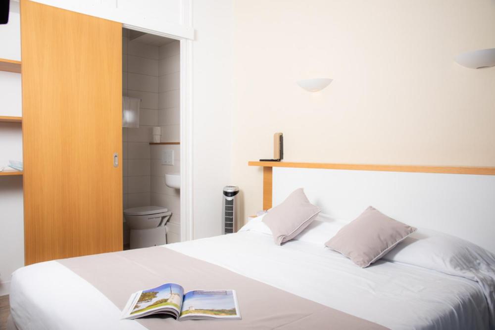 Un ou plusieurs lits dans un hébergement de l'établissement Hotel Les Dunes