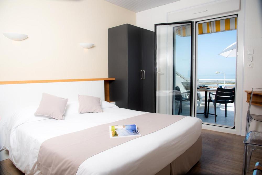 Un ou plusieurs lits dans un hébergement de l'établissement Hotel Les Dunes