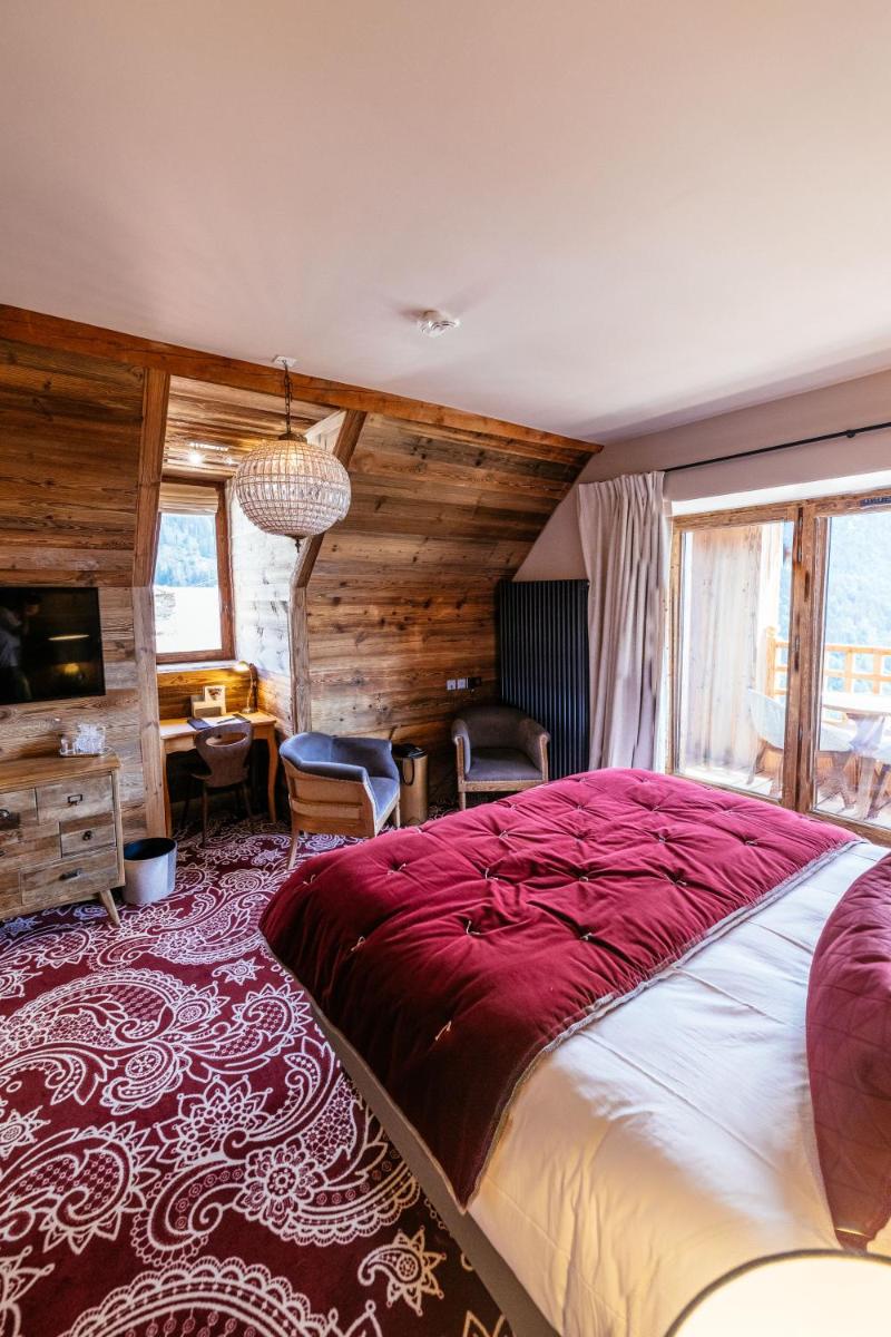 Un ou plusieurs lits dans un hébergement de l'établissement Hotel Le V de Vaujany