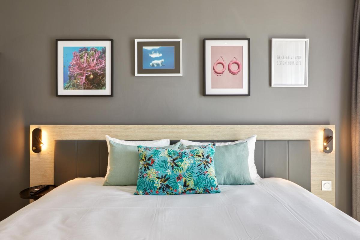 Un ou plusieurs lits dans un hébergement de l'établissement Aparthotel & Spa Adagio Vannes