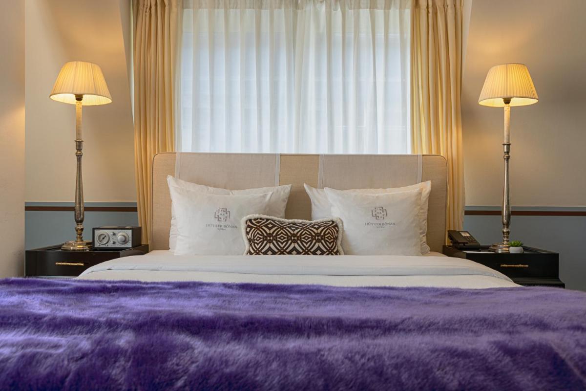 Ein Bett oder Betten in einem Zimmer der Unterkunft House of Hütter- Heidelberg Suites Boutique