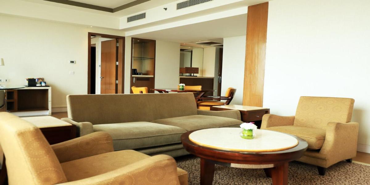 a living room with a couch and chairs and a table at Crowne Plaza New Delhi Okhla by IHG in New Delhi
