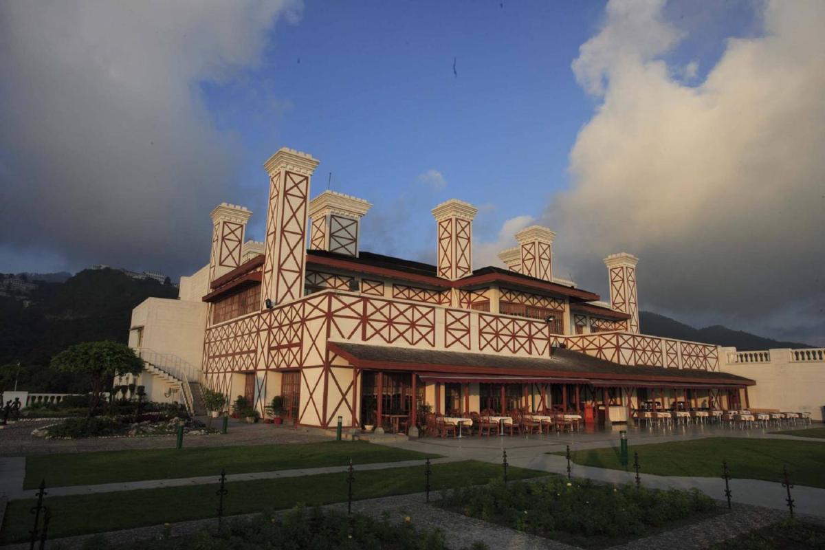 a large building with tables and chairs in front of it at Jaypee Residency Manor in Mussoorie