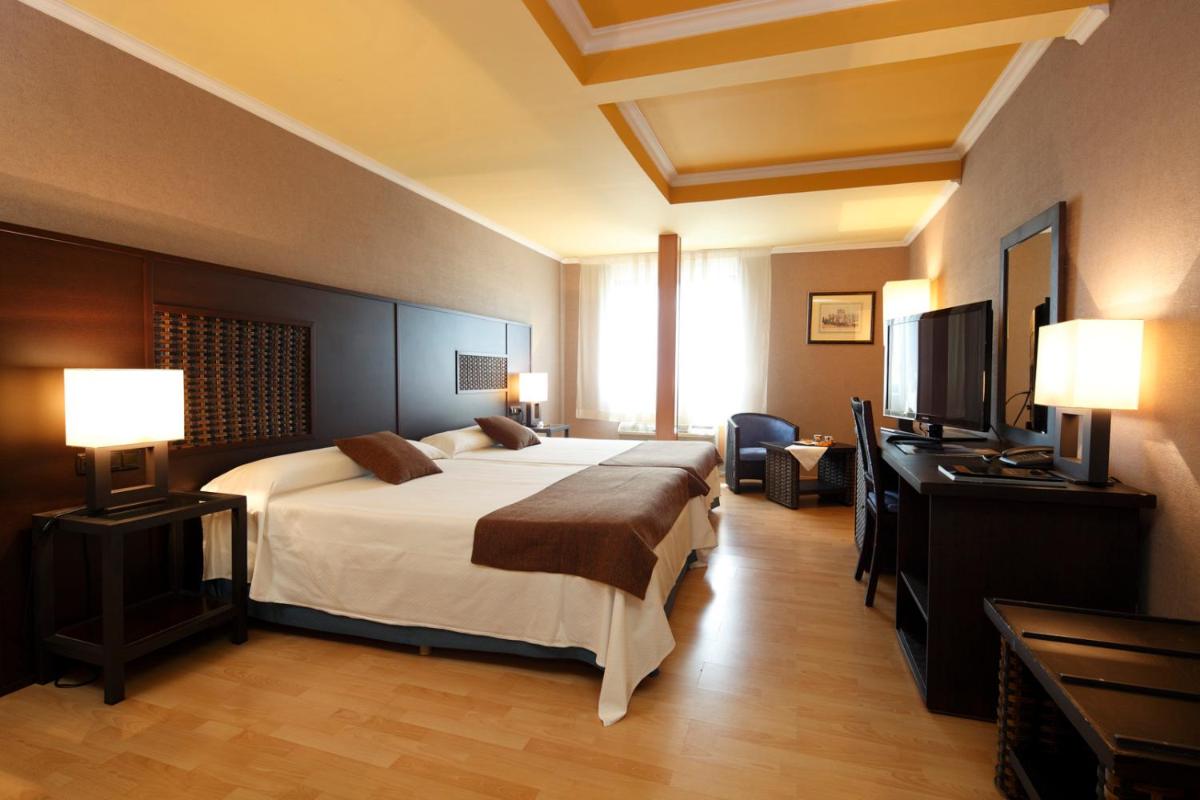 Cama o camas de una habitación en Hotel Spa Congreso