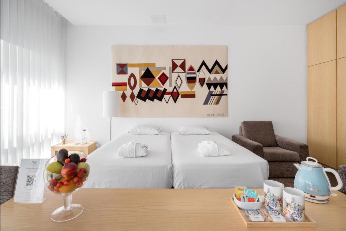 Uma cama ou camas num quarto em Boticas Hotel Art & SPA