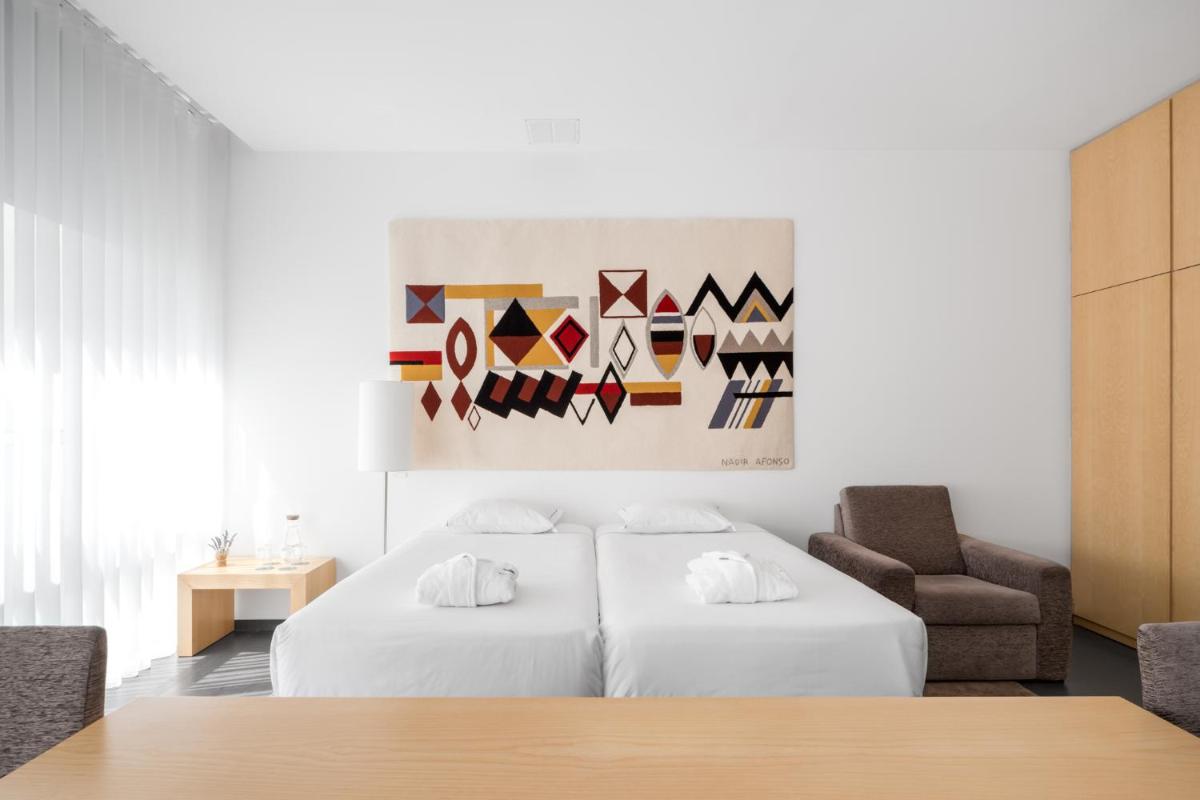 Uma cama ou camas num quarto em Boticas Hotel Art & SPA
