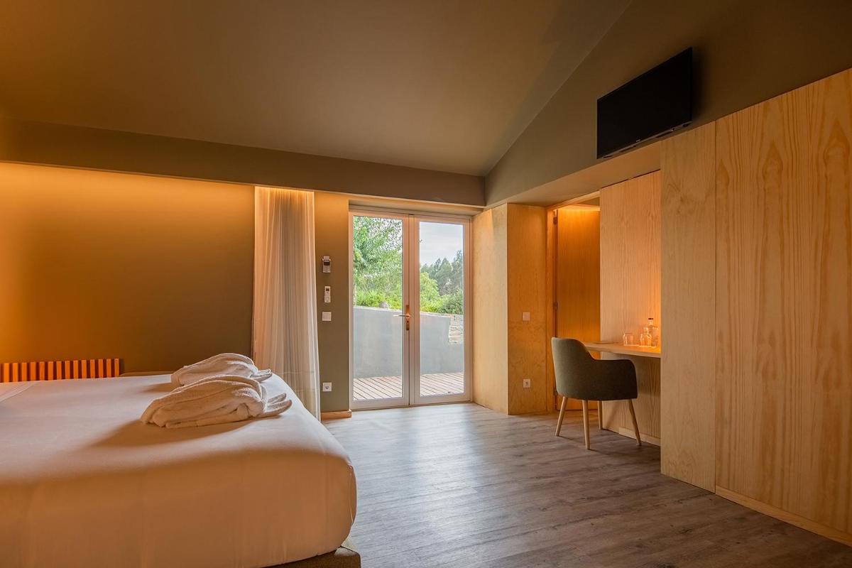 Uma cama ou camas num quarto em Quinta do Pedregal Hotel & Spa