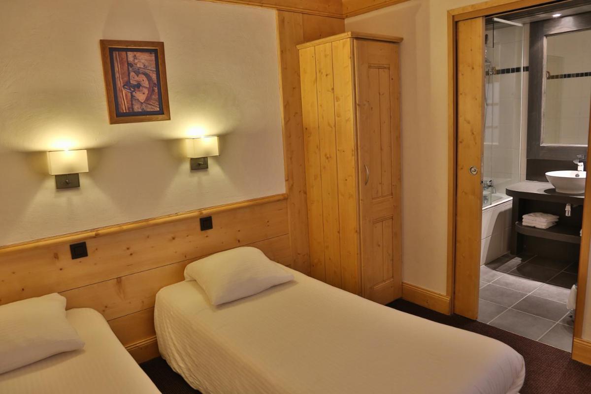 Un ou plusieurs lits dans un hébergement de l'établissement Hotel Club Le Crêt