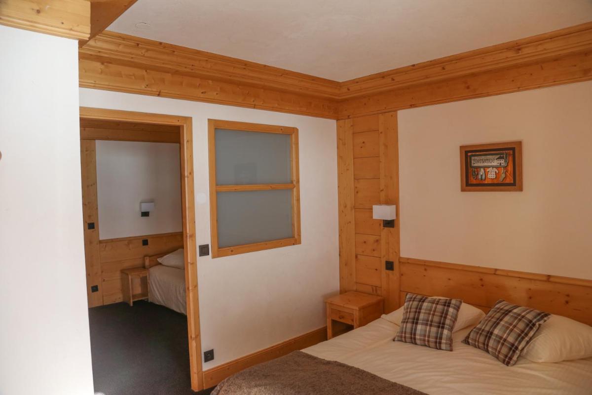 Un ou plusieurs lits dans un hébergement de l'établissement Hotel Club Le Crêt