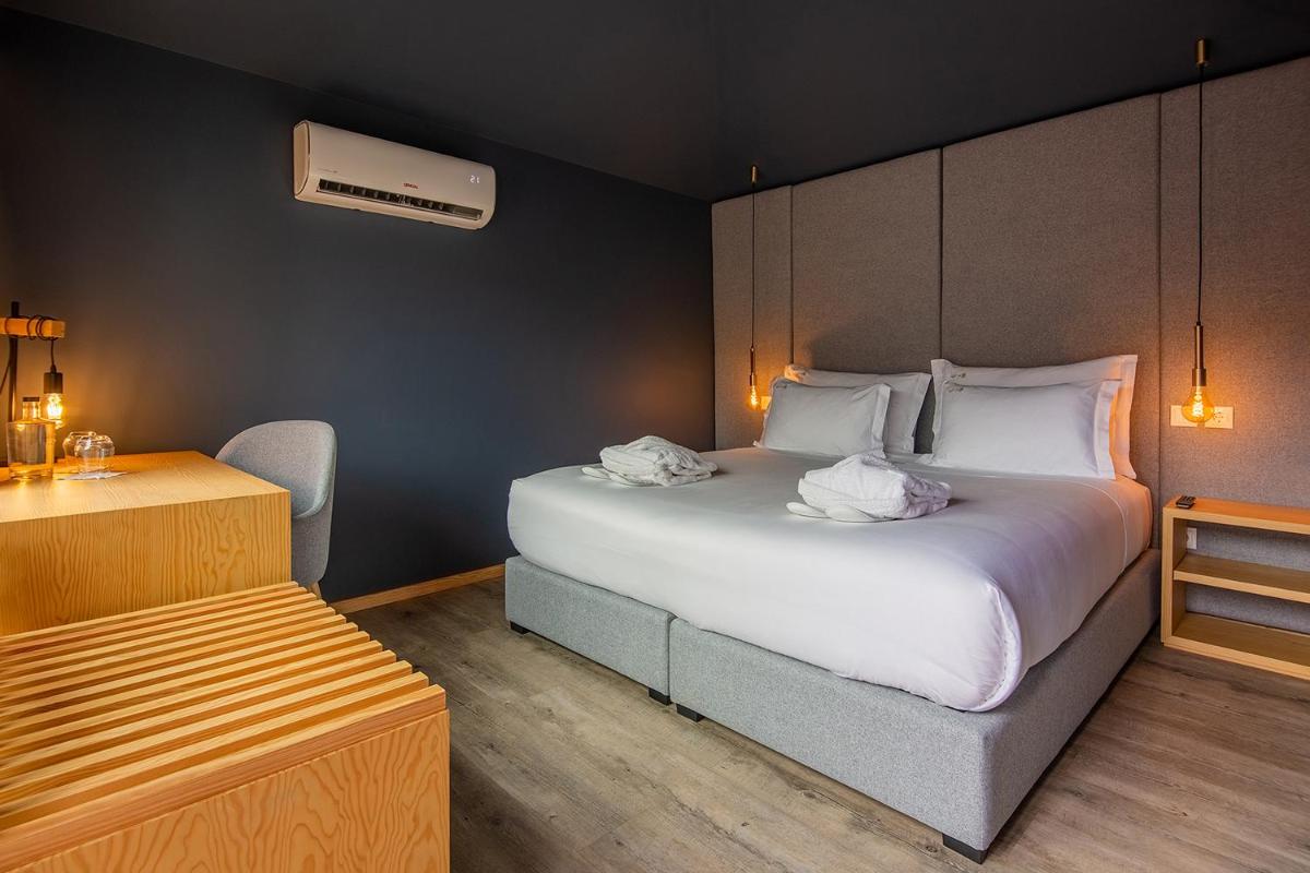 Uma cama ou camas num quarto em Quinta do Pedregal Hotel & Spa
