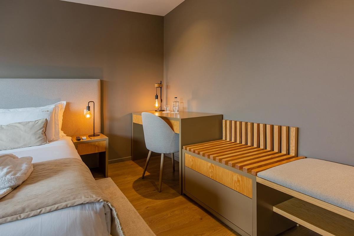 Uma cama ou camas num quarto em Quinta do Pedregal Hotel & Spa