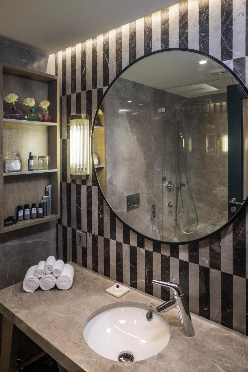 a bathroom with a sink and a mirror at The Park Bangalore, MG Road in Bengaluru a bathroom with a sink and a mirror at The Park Bangalore, MG Road in Bengaluru