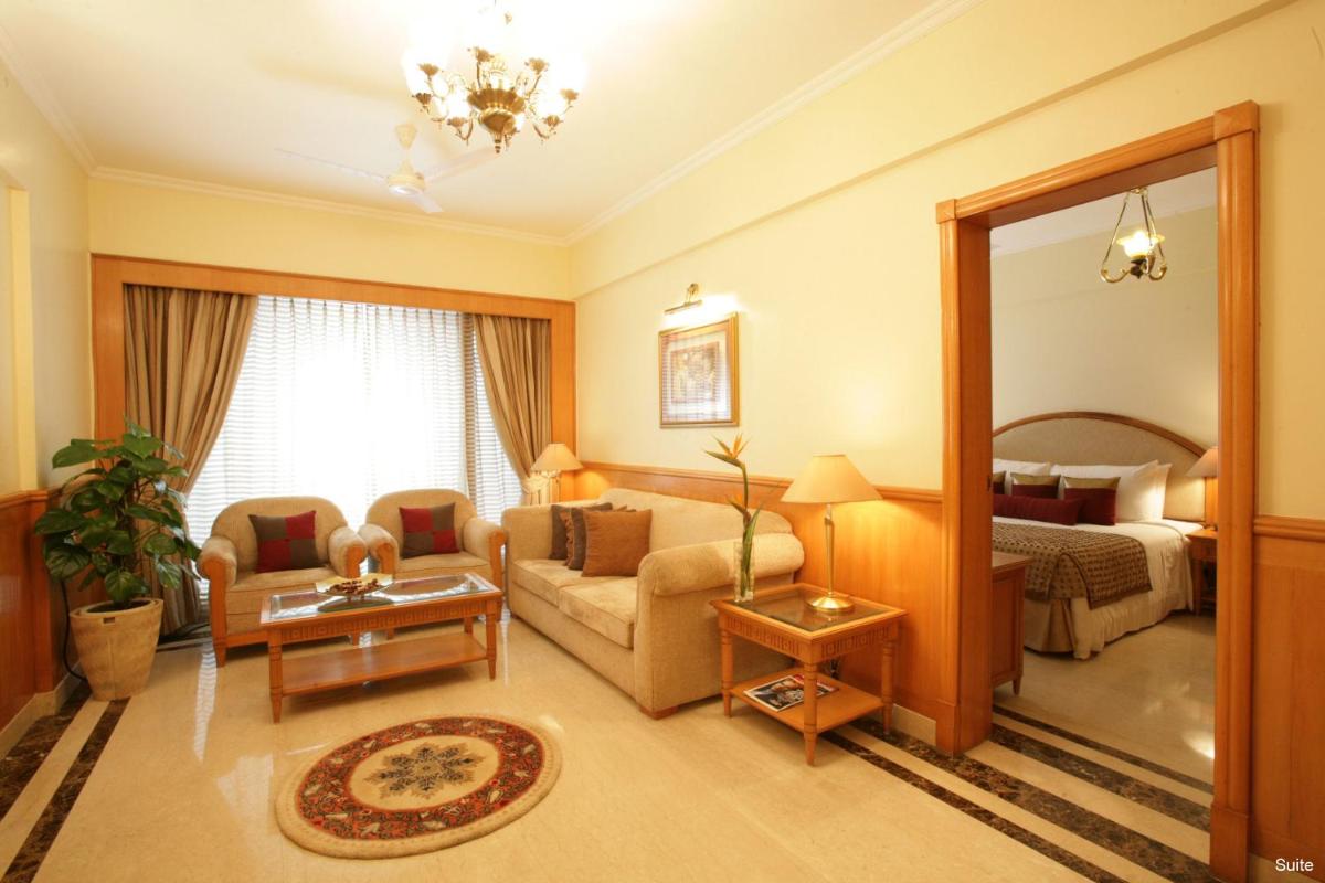 a living room with a couch and a bed at Jaypee Siddharth in New Delhi a living room with a couch and a bed at Jaypee Siddharth in New Delhi