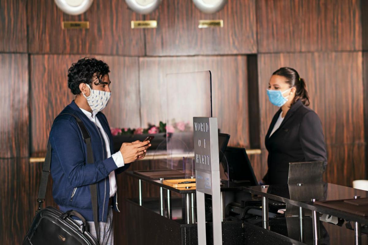 two people in an office with masks on their faces at Hyatt Regency Kolkata in Kolkata two people in an office with masks on their faces at Hyatt Regency Kolkata in Kolkata