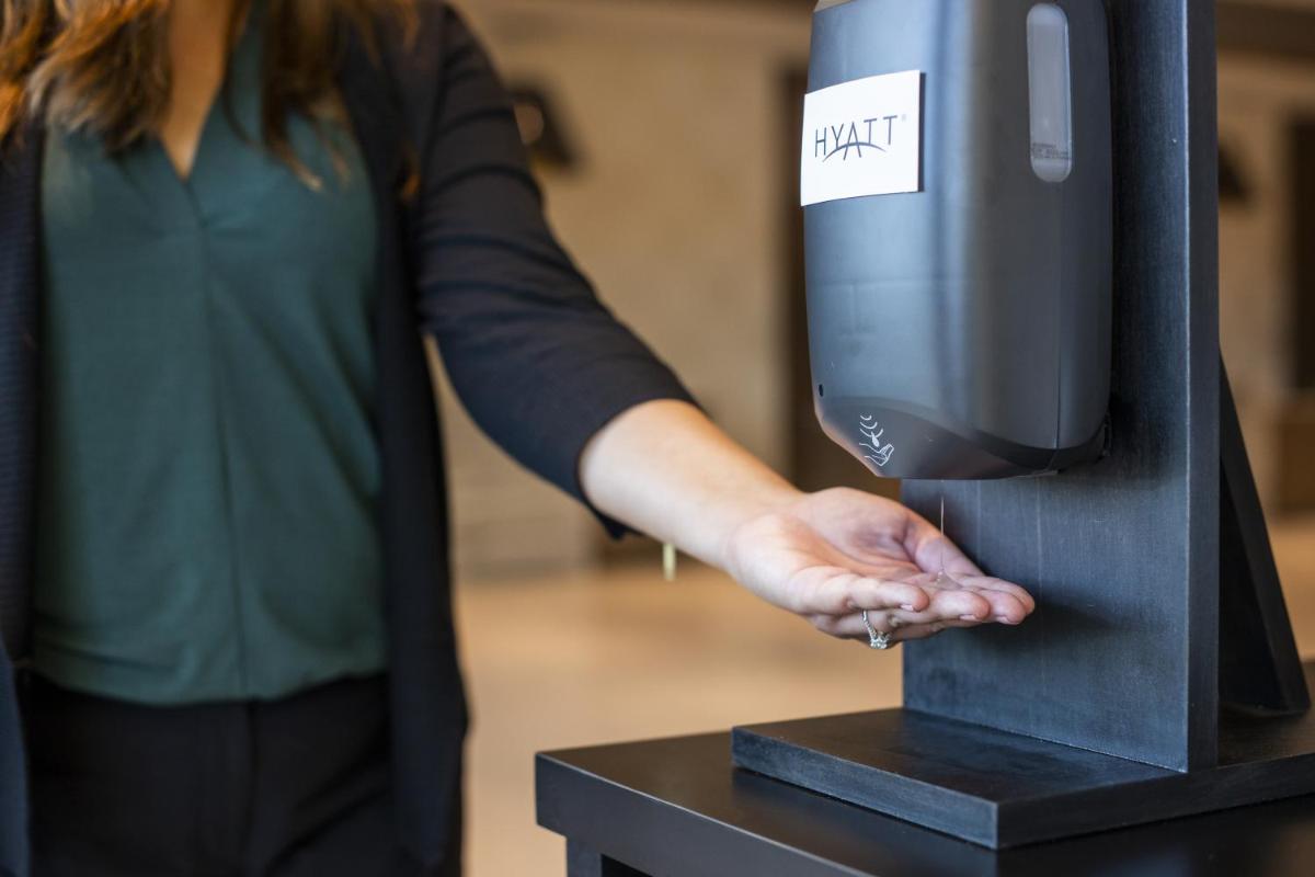 a woman is inserting her hand into a drink dispenser at Hyatt Regency Kolkata in Kolkata a woman is inserting her hand into a drink dispenser at Hyatt Regency Kolkata in Kolkata
