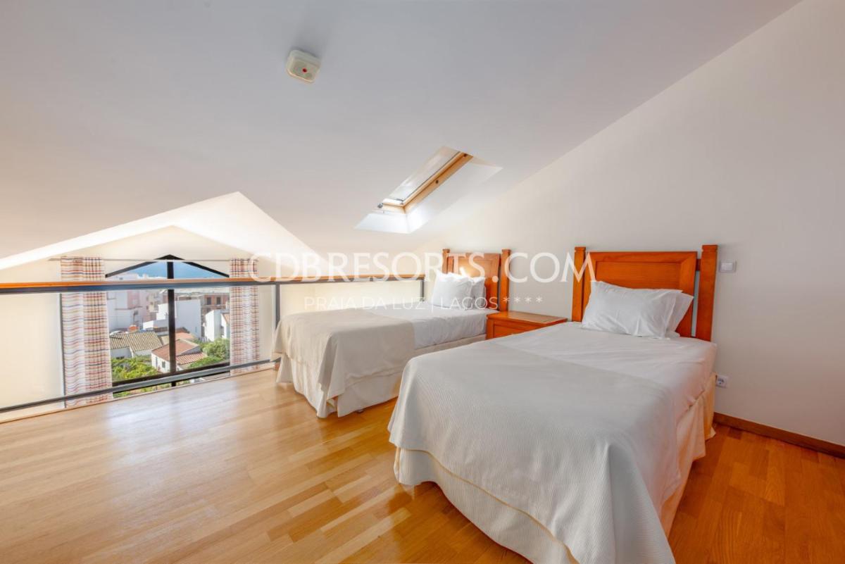 Uma cama ou camas num quarto em Estrela da Luz Resort