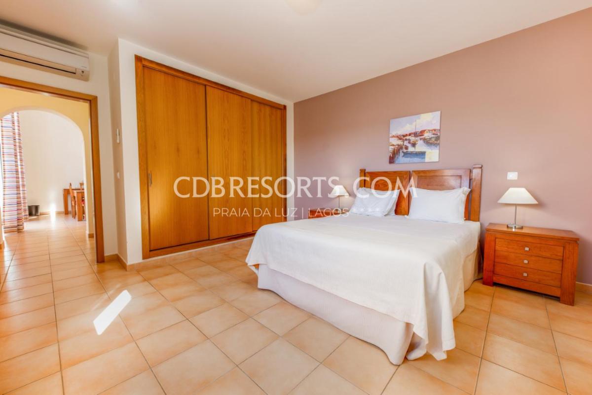 Uma cama ou camas num quarto em Estrela da Luz Resort