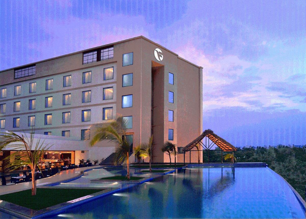 a hotel with a swimming pool in front of a building at Fortune Select Grand Ridge, Tirupati - Member ITC Hotels' Group in Tirupati