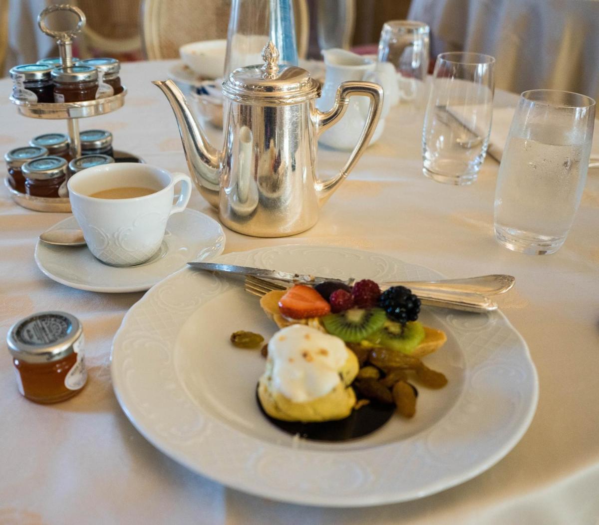 a plate of food on a table with a cup of coffee at Novotel Hyderabad Airport in Hyderabad