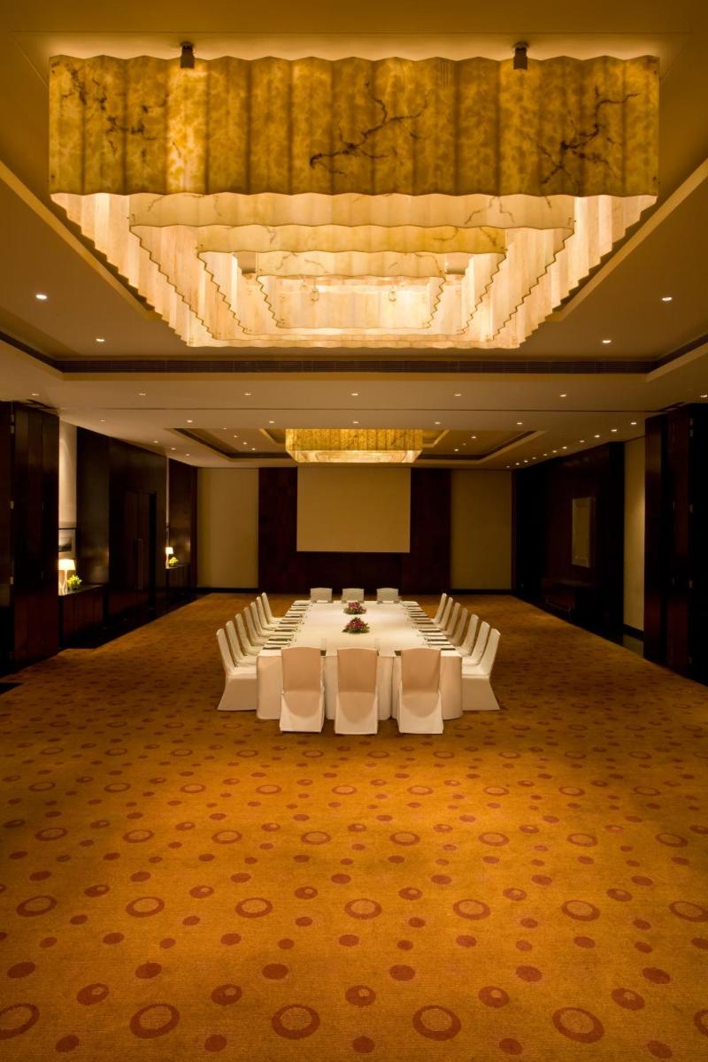 a large banquet hall with white tables and chairs at Hyatt Hyderabad Gachibowli in Hyderabad