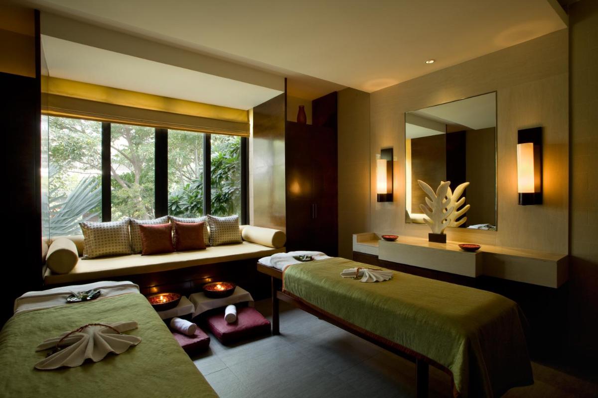 a hotel room with two beds and a window at Hyatt Hyderabad Gachibowli in Hyderabad