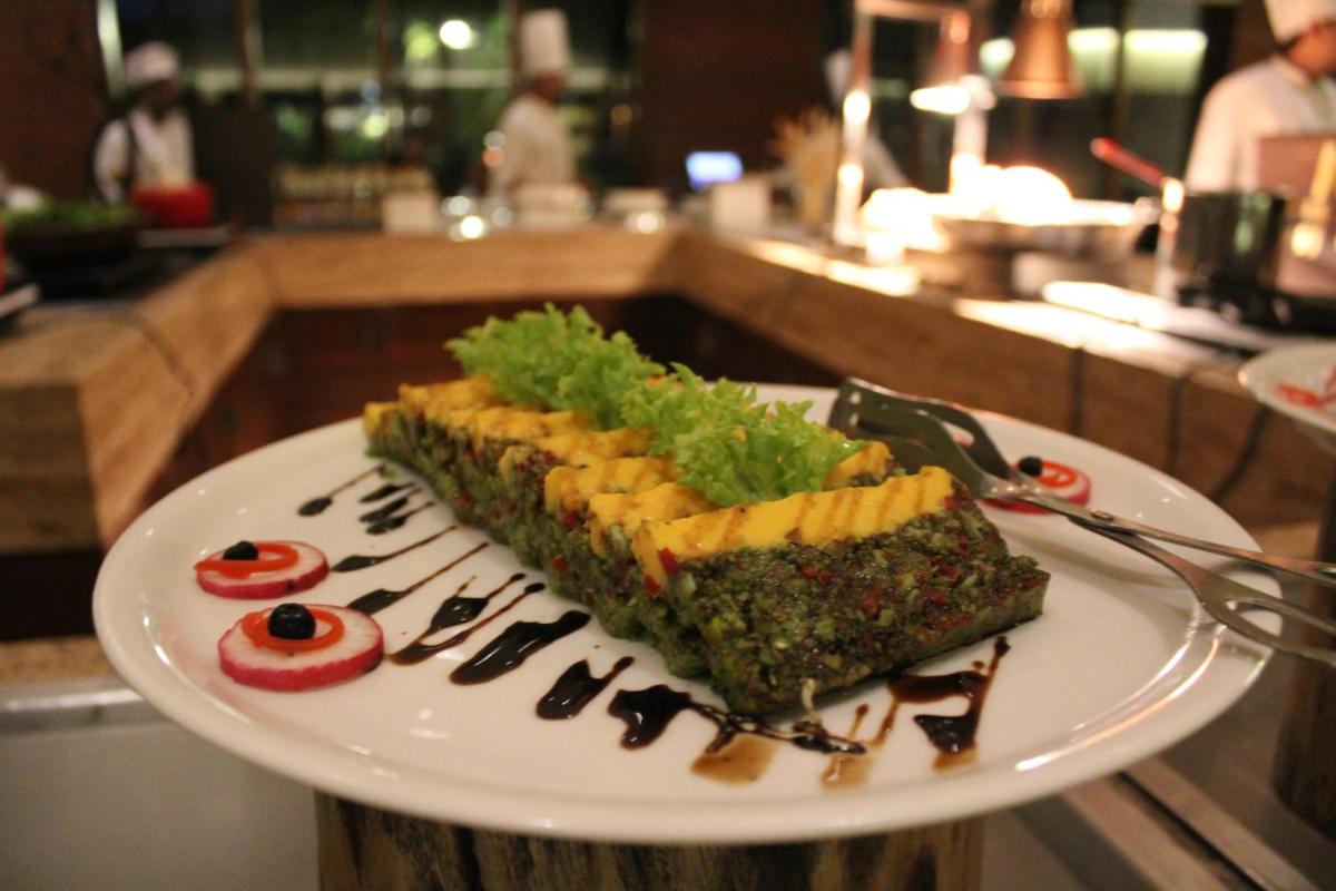 a white plate with a piece of food on it at Hyatt Hyderabad Gachibowli in Hyderabad