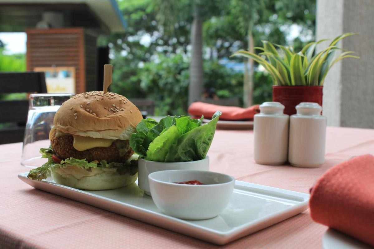 a sandwich and salad on a plate on a table at Hyatt Hyderabad Gachibowli in Hyderabad
