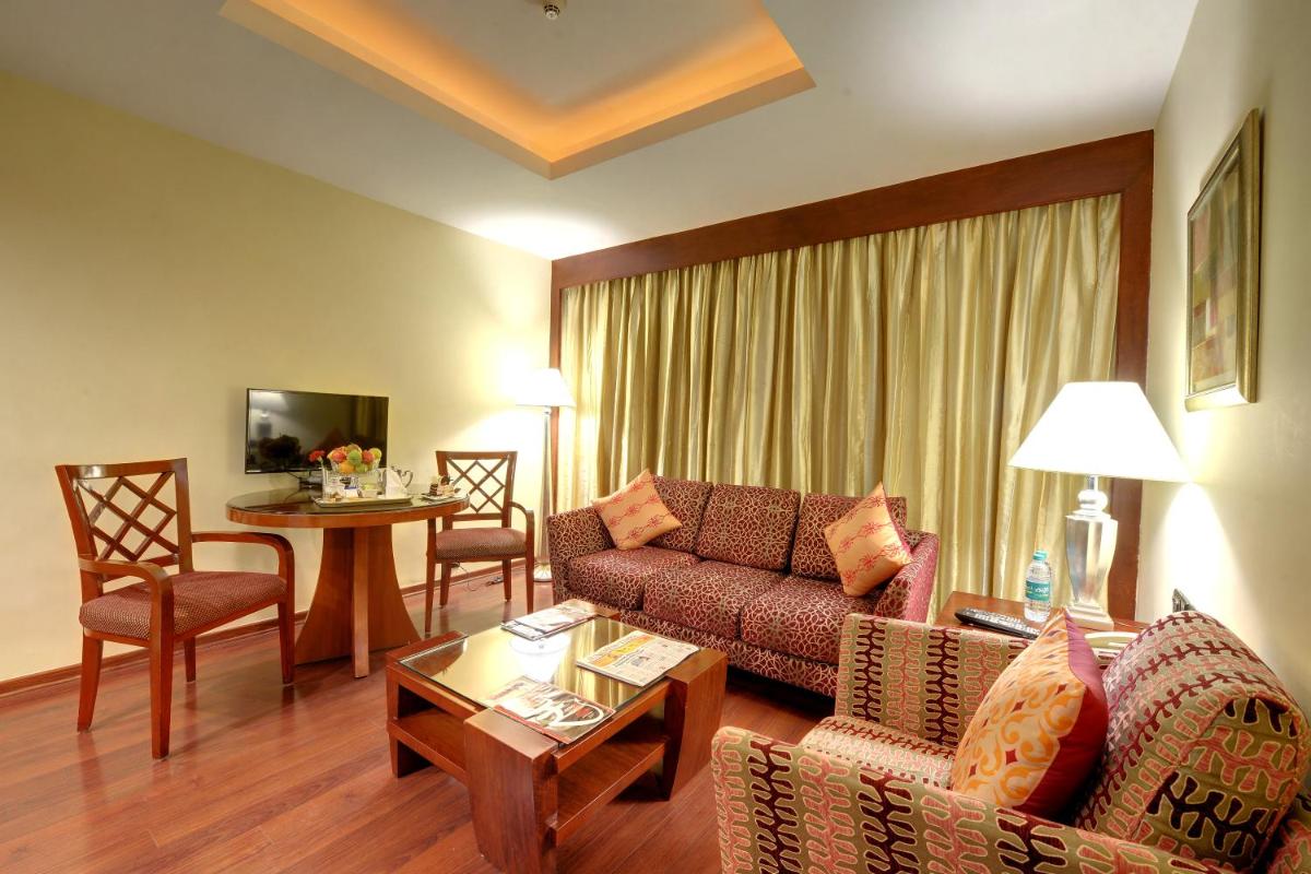a living room with a couch and a table at Fortune Select JP Cosmos, Bengaluru - Member ITC Hotels' Group in Bengaluru