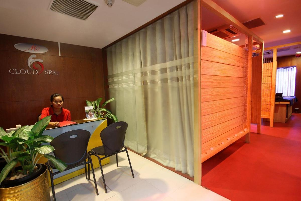 a woman sitting at a counter in a room with a table at Fortune Select JP Cosmos, Bengaluru - Member ITC Hotels' Group in Bengaluru