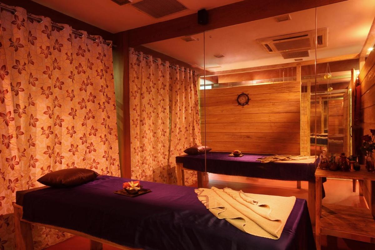a room with two beds and a table in it at Fortune Select JP Cosmos, Bengaluru - Member ITC Hotels' Group in Bengaluru