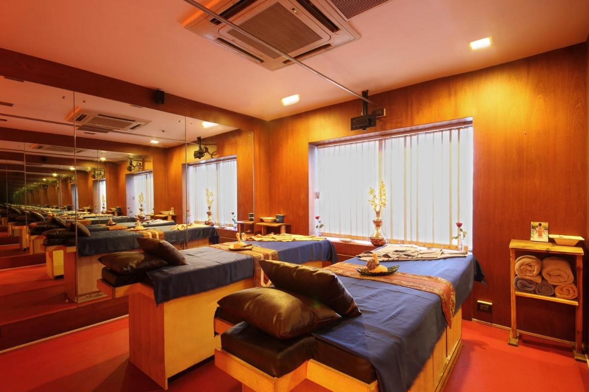a room with a row of beds and chairs at Fortune Select JP Cosmos, Bengaluru - Member ITC Hotels' Group in Bengaluru