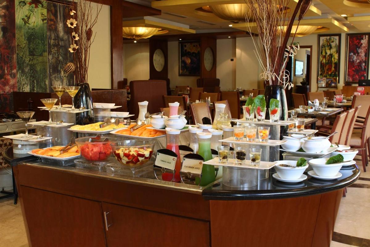 a buffet of food on a table in a restaurant at Fortune Select JP Cosmos, Bengaluru - Member ITC Hotels' Group in Bengaluru