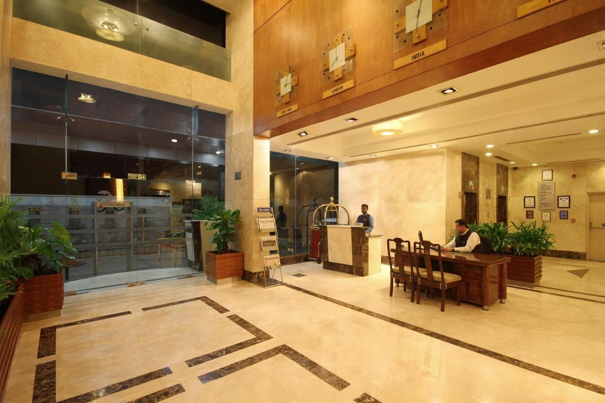 a person sitting at a table in a lobby at Fortune Select JP Cosmos, Bengaluru - Member ITC Hotels' Group in Bengaluru