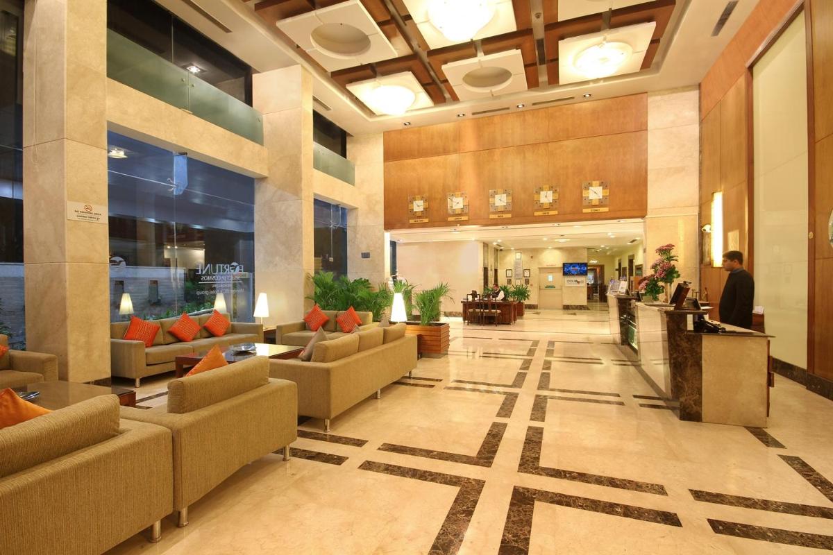 a lobby with couches and chairs in a building at Fortune Select JP Cosmos, Bengaluru - Member ITC Hotels' Group in Bengaluru +72 photos