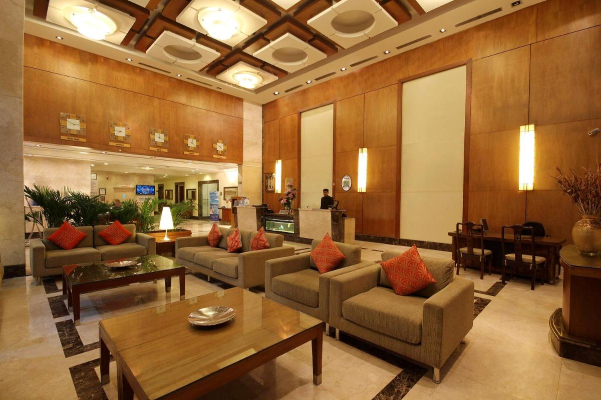 a lobby with couches and tables in a building at Fortune Select JP Cosmos, Bengaluru - Member ITC Hotels' Group in Bengaluru