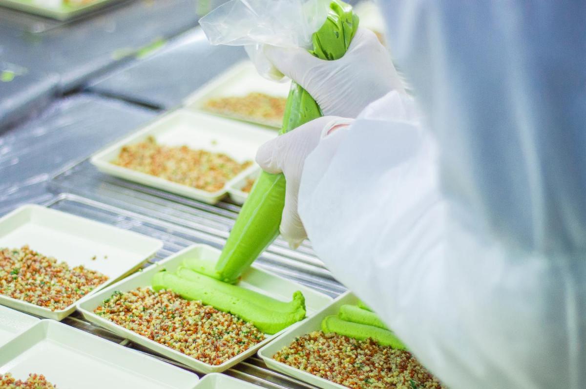 a person holding a stalk of celery in a laboratory at Novotel Kochi Infopark in Cochin
