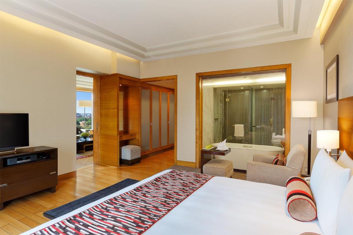 a hotel room with a bed and a television at Crowne Plaza Today Gurugram by IHG in Gurgaon