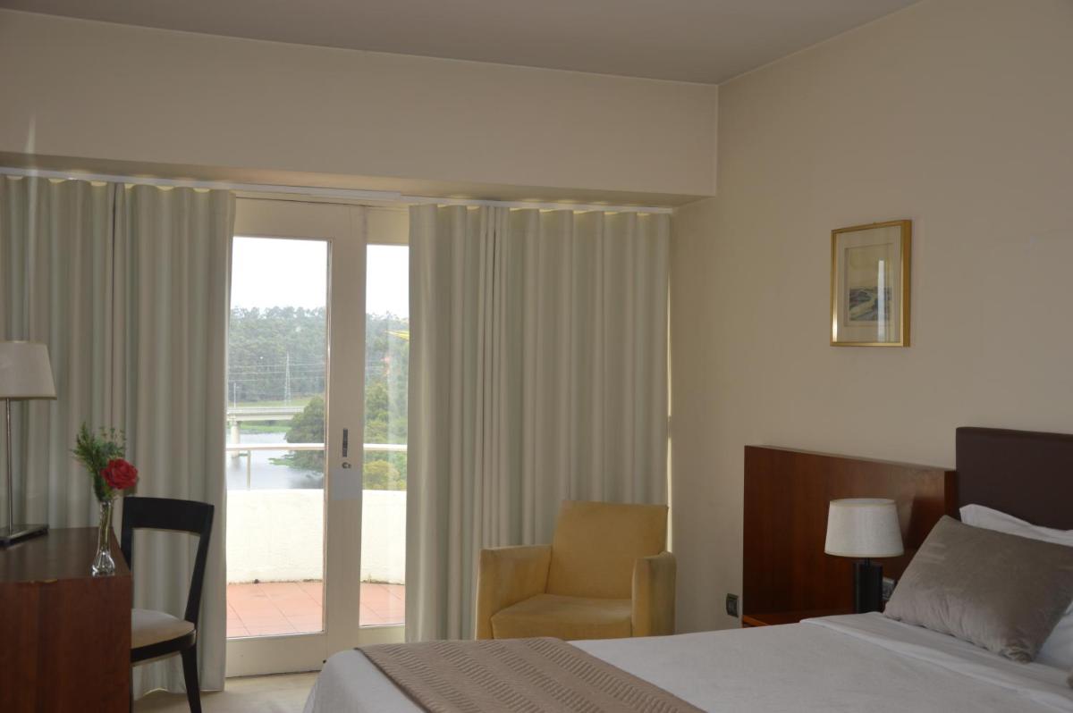 Uma cama ou camas num quarto em Santana Hotel & SPA