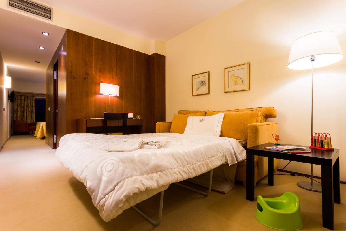 Uma cama ou camas num quarto em Santana Hotel & SPA