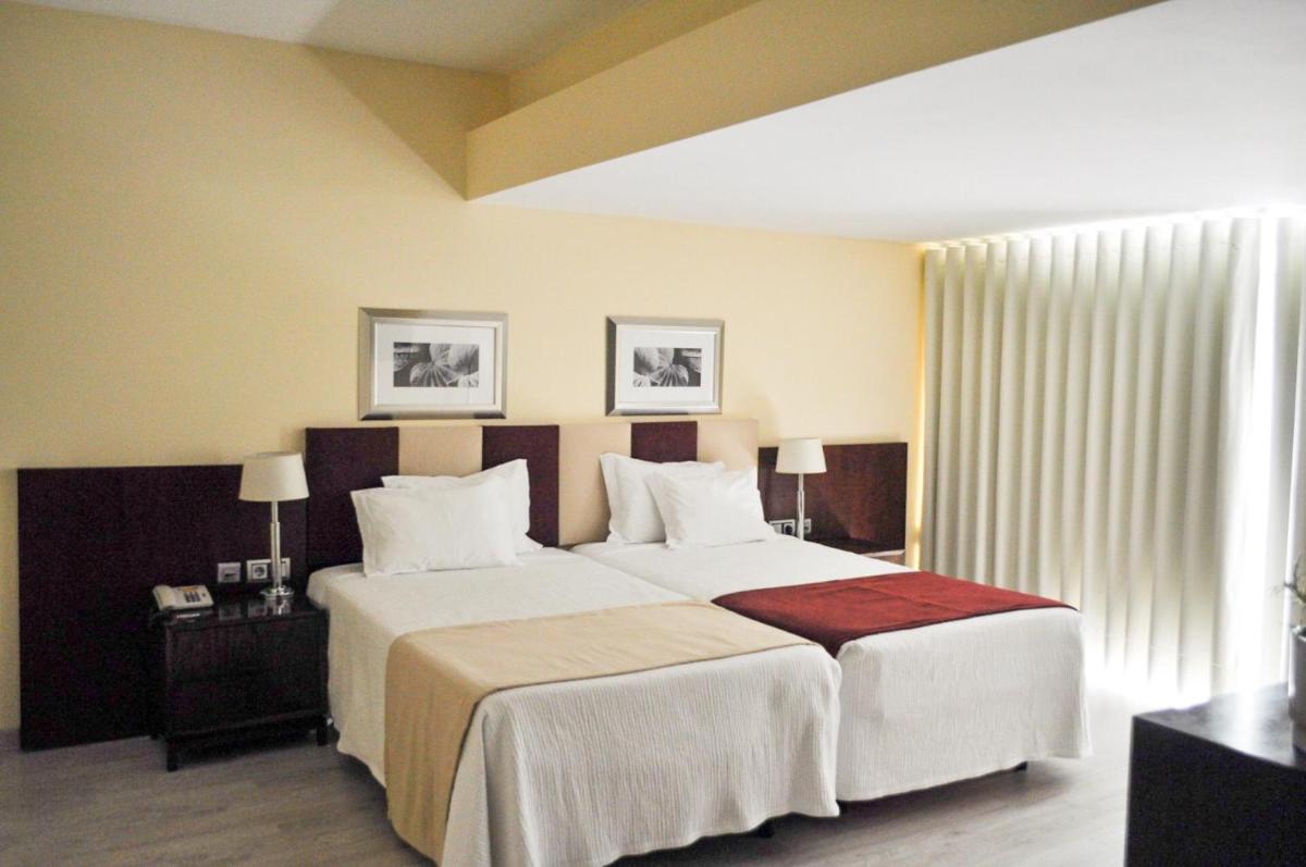 Uma cama ou camas num quarto em Santana Hotel & SPA