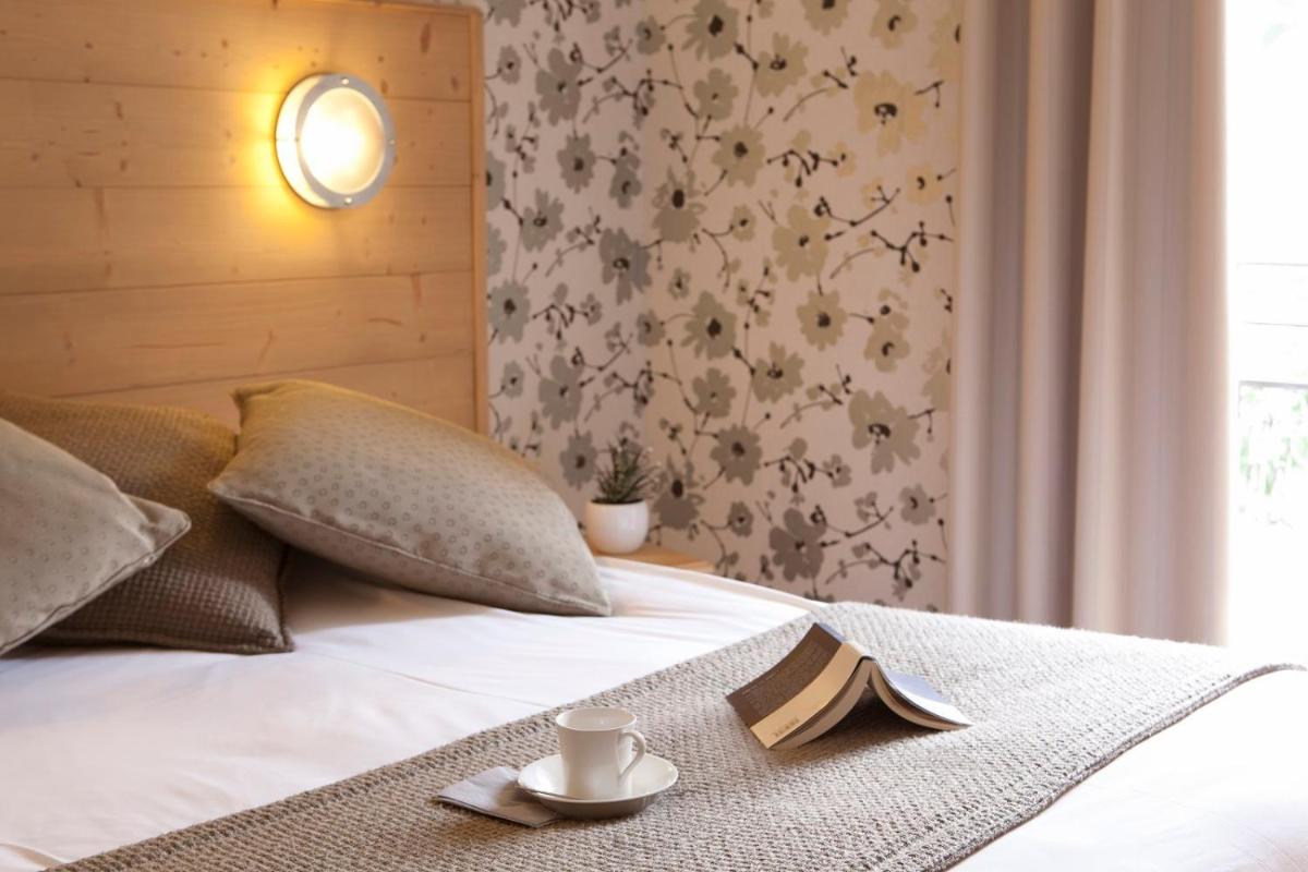 Un ou plusieurs lits dans un hébergement de l'établissement Hotel le Chalet