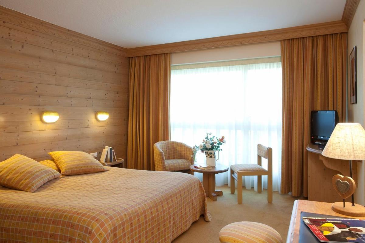 Un ou plusieurs lits dans un hébergement de l'établissement Hotel le Chalet