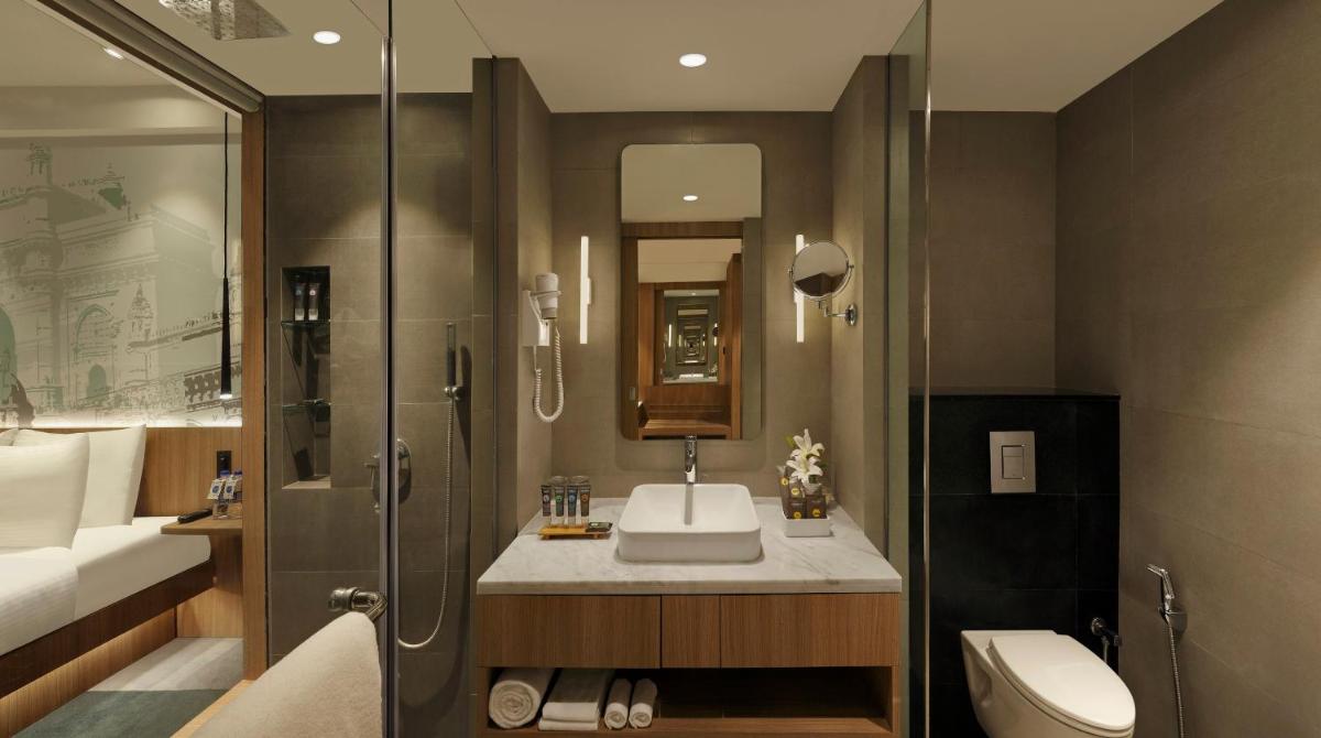 a bathroom with a sink and a toilet and a shower at Novotel Mumbai Juhu Beach in Mumbai