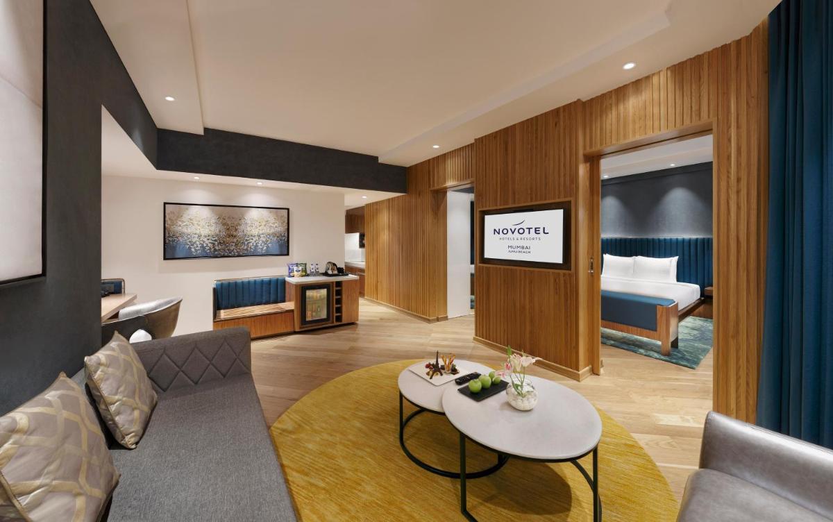 a living room with a couch and a bed at Novotel Mumbai Juhu Beach in Mumbai