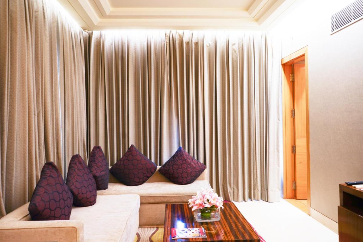 a living room with purple pillows on a couch at Crowne Plaza Today Gurugram by IHG in Gurgaon