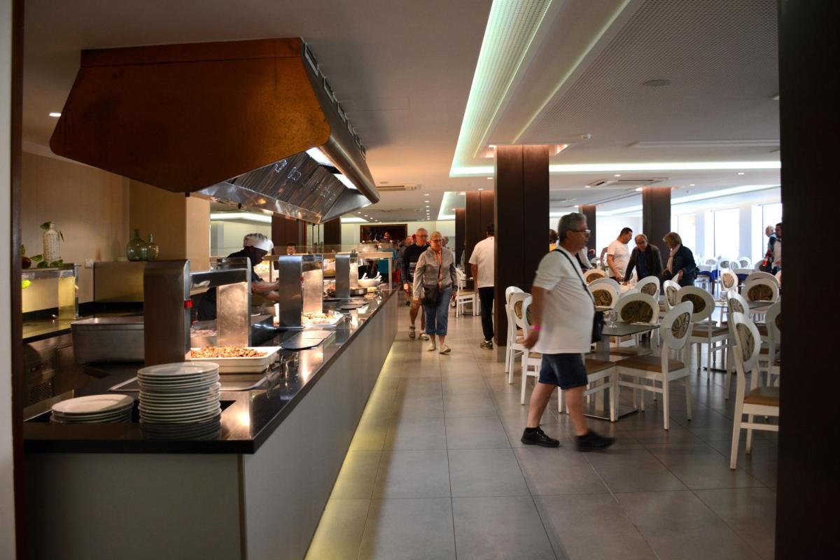 un grupo de personas caminando alrededor de un restaurante con un mostrador en Don Angel & SPA & Padel- Adults Recommended, en Santa Susanna 106 fotos más