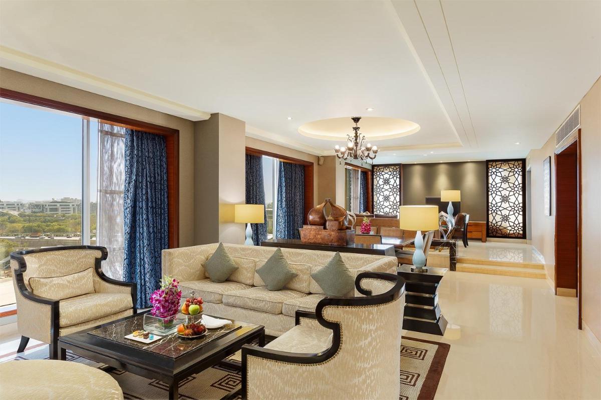 a living room with a couch and a table at Crowne Plaza Today Gurugram by IHG in Gurgaon