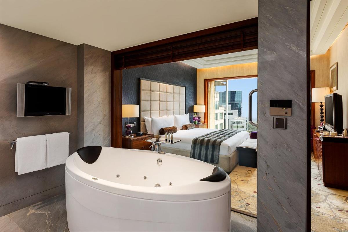 a hotel room with a tub and a bed at Crowne Plaza Today Gurugram by IHG in Gurgaon