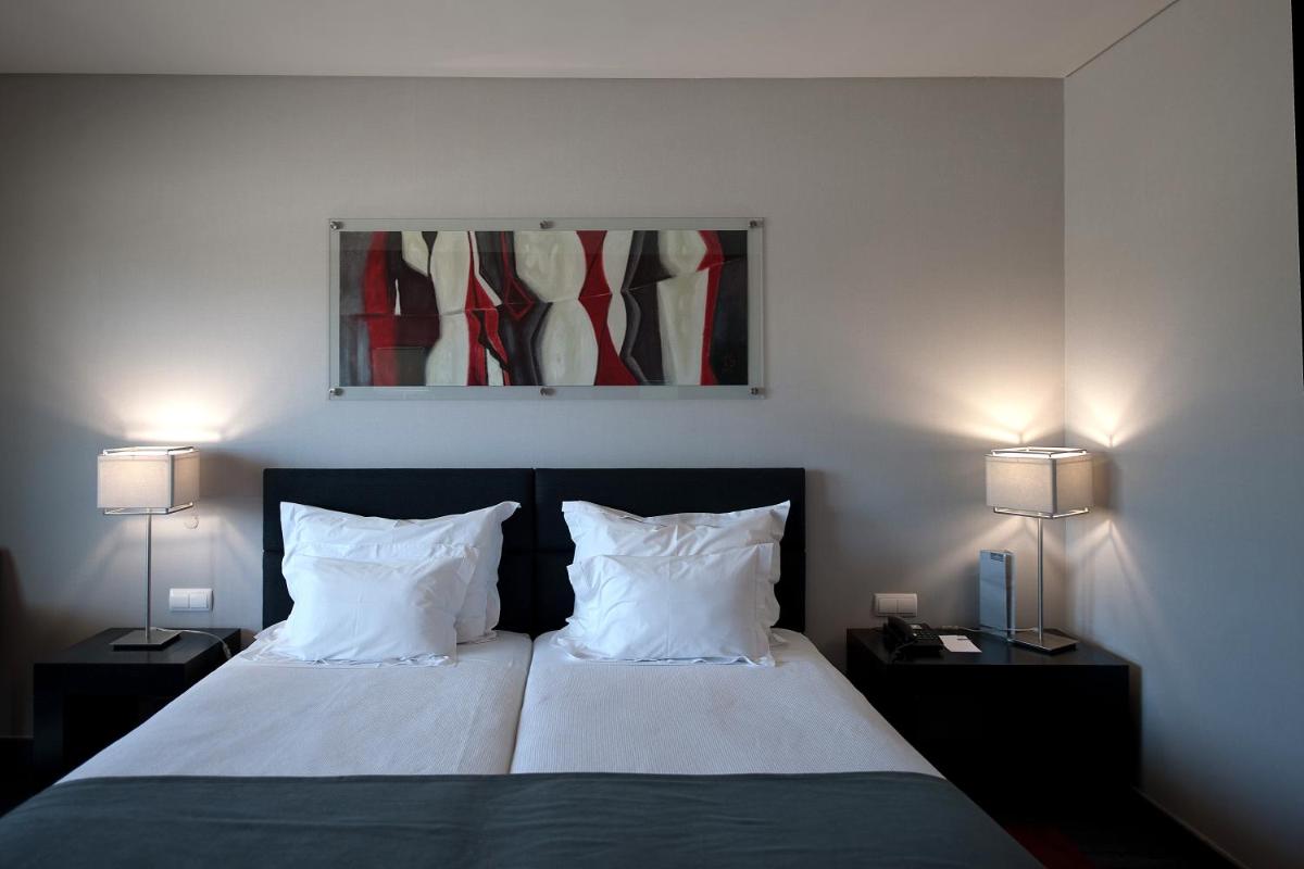 Uma cama ou camas num quarto em Vila Gale Lagos