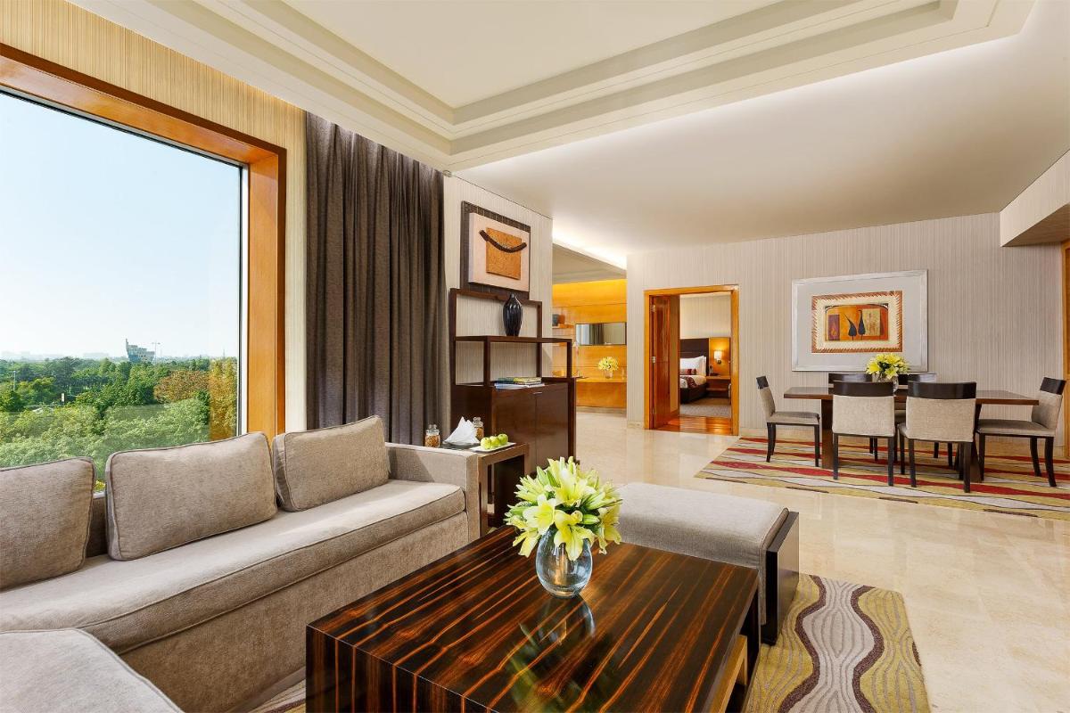 a living room with a couch and a table at Crowne Plaza Today Gurugram by IHG in Gurgaon